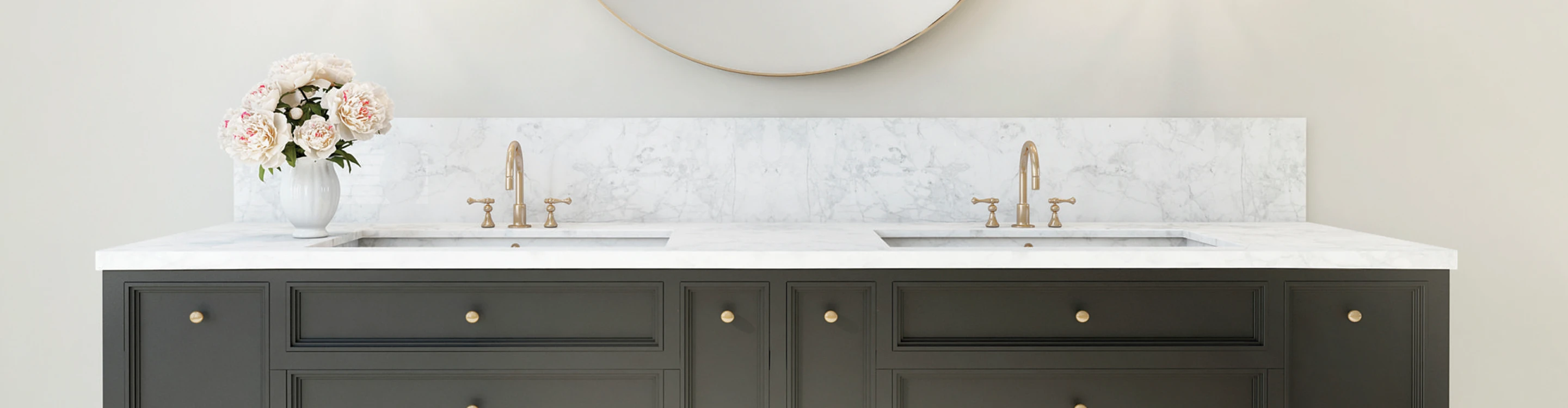 white stone countertop in bathroom with brass hardware and brown cabinets