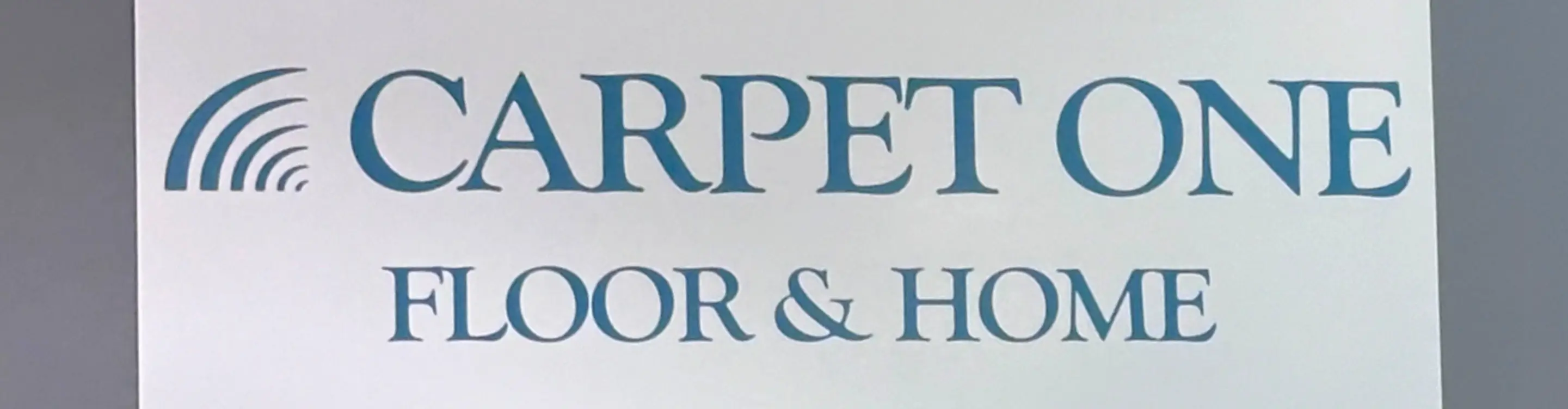 carpet one floor & home logo on store showroom wall