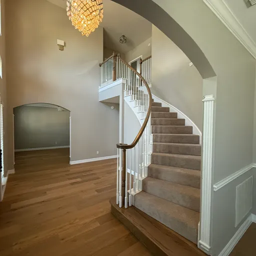 Sweeping staircase in Dallas, TX with carpet stair runner